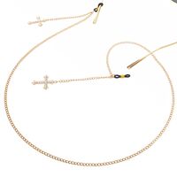 Gold-colored metal non-slip chain, with pendant cross with rhinestones, for glasses and masks GL022
