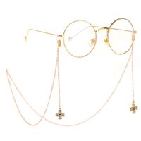 Gold-colored metal non-slip chain, with pendant cross with rhinestone, for glasses and masks GL225