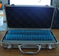 Prism lens set in metal case, 58 pieces