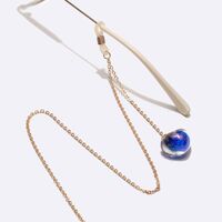 Gold-colored metal non-slip chain, with peach-blue heart pendant, for glasses and masks GL1481