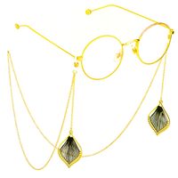 Gold-colored metal non-slip chain, with pendant wire leaf, for glasses and masks GL637