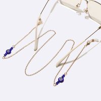 Gold-colored metal non-slip chain, with gold crystals and blue eyes, for glasses and masks GL1733