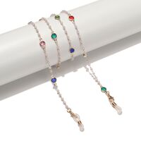 Gold-colored metal non-slip chain, with colored glass and pearl, for glasses and masks GL1542